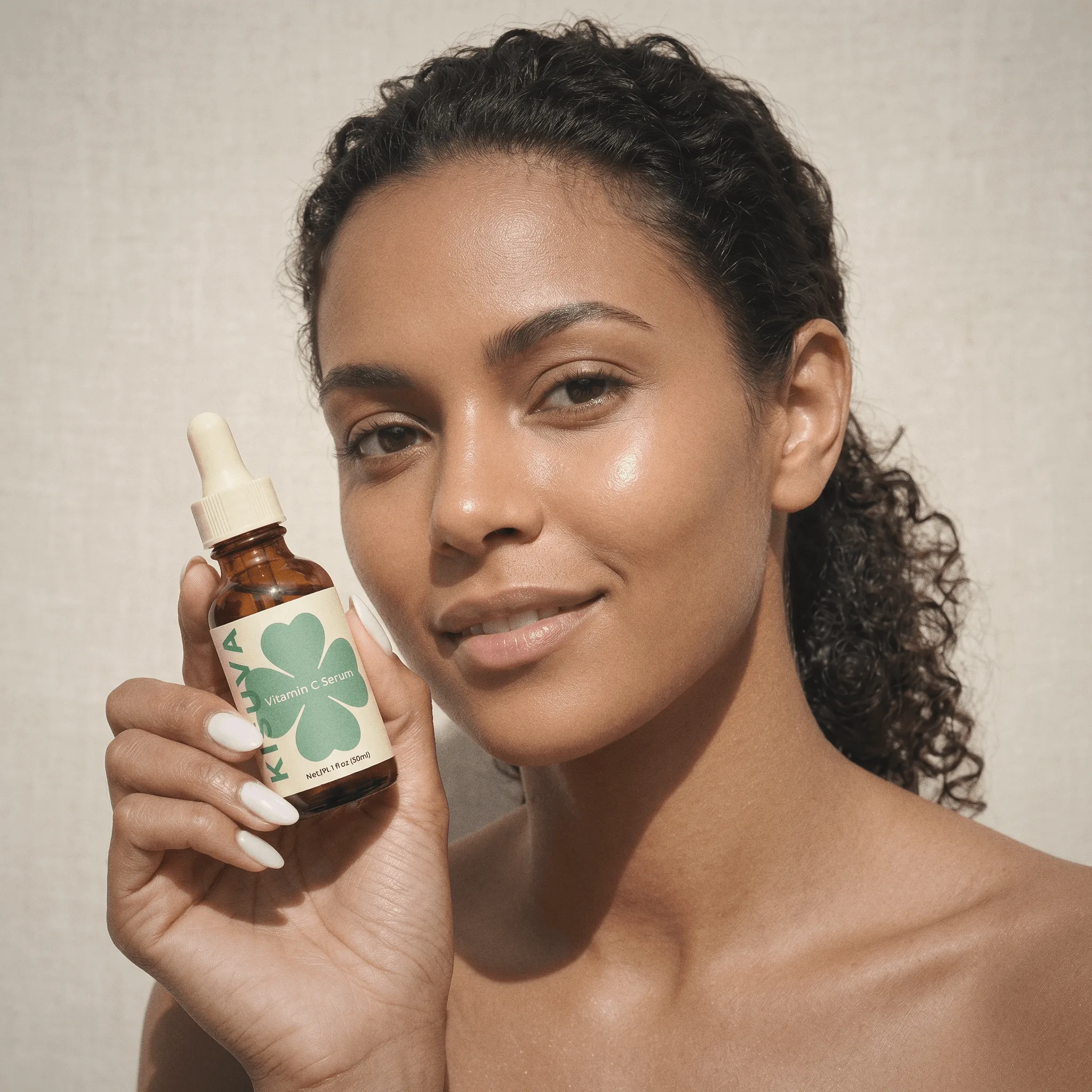 Woman applying Kisuva Vitamin C Serum with dropper