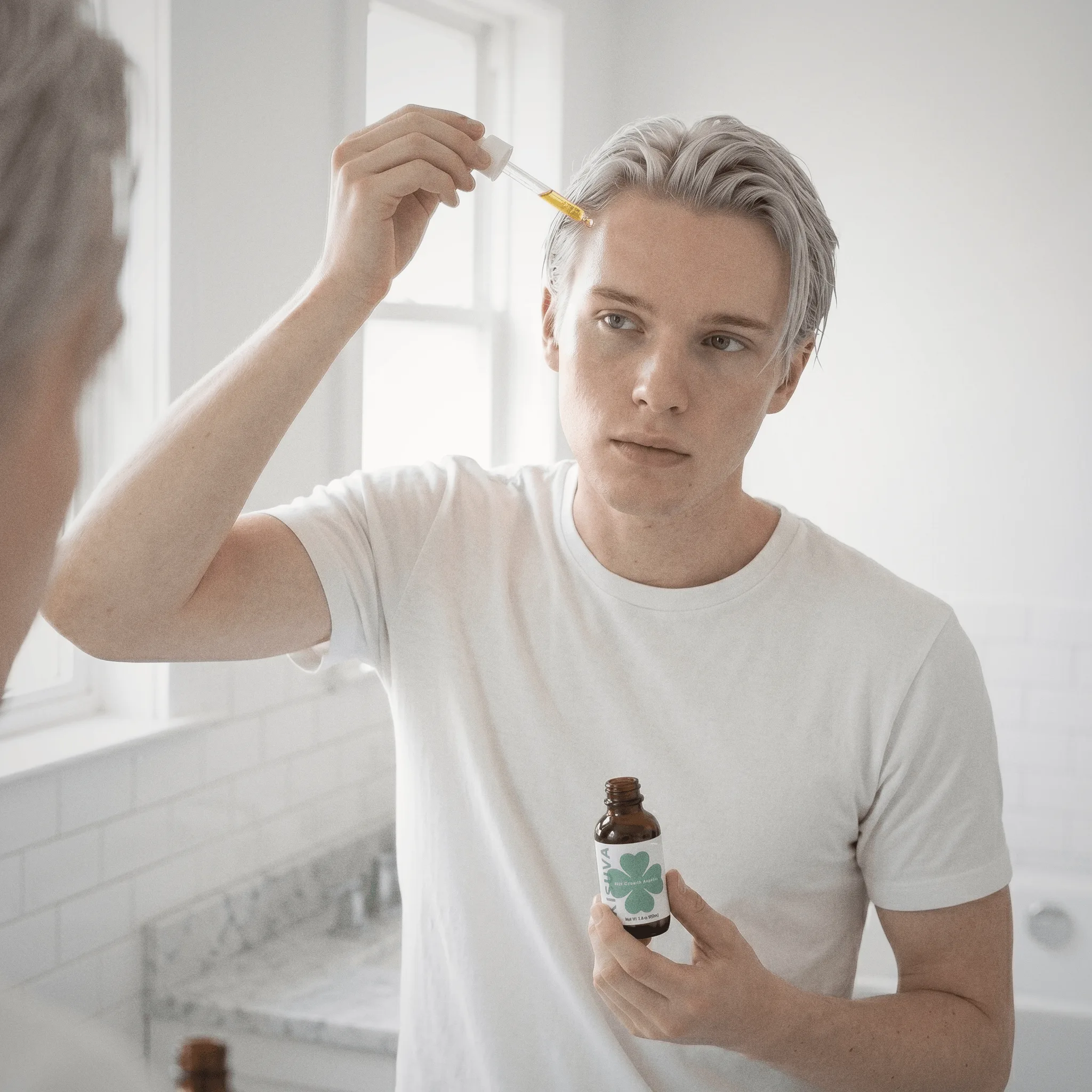 Blonde man holding Kisuva Hair Growth Serum