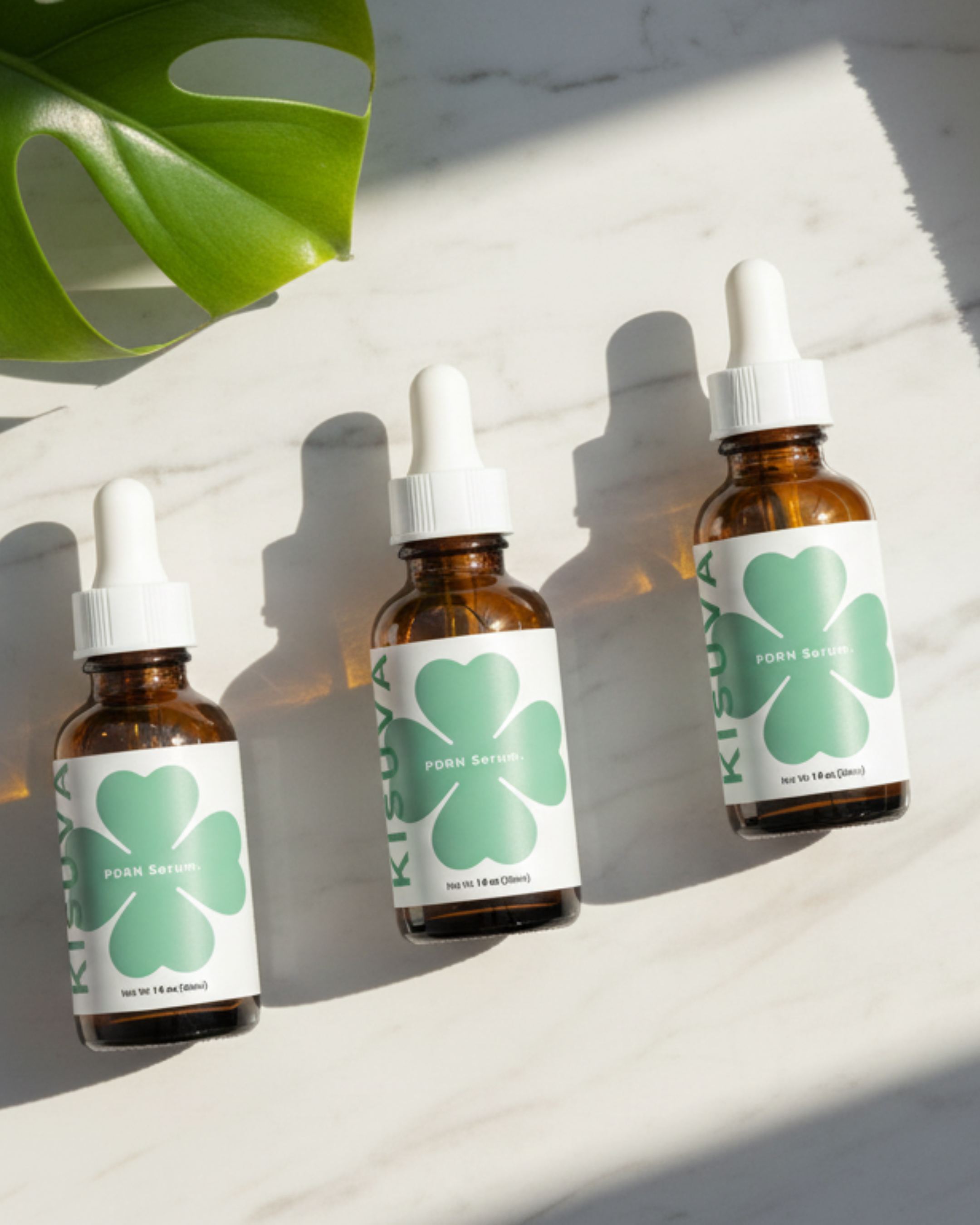 Kisuva PDRN Brightening Serum trio bottles on marble