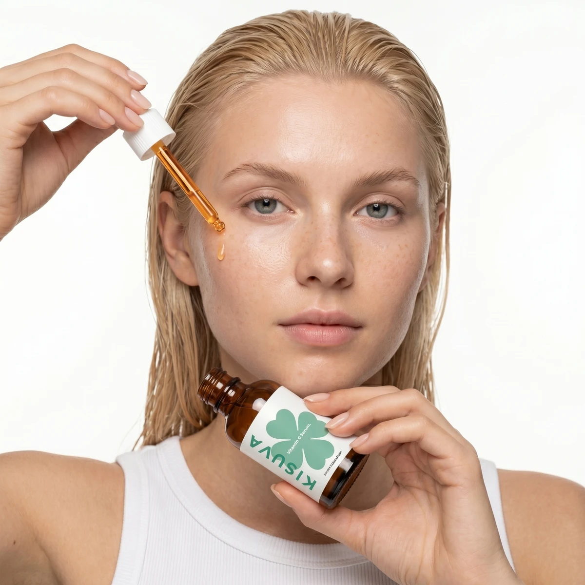 Model applying Kisuva Vitamin C Serum with dropper