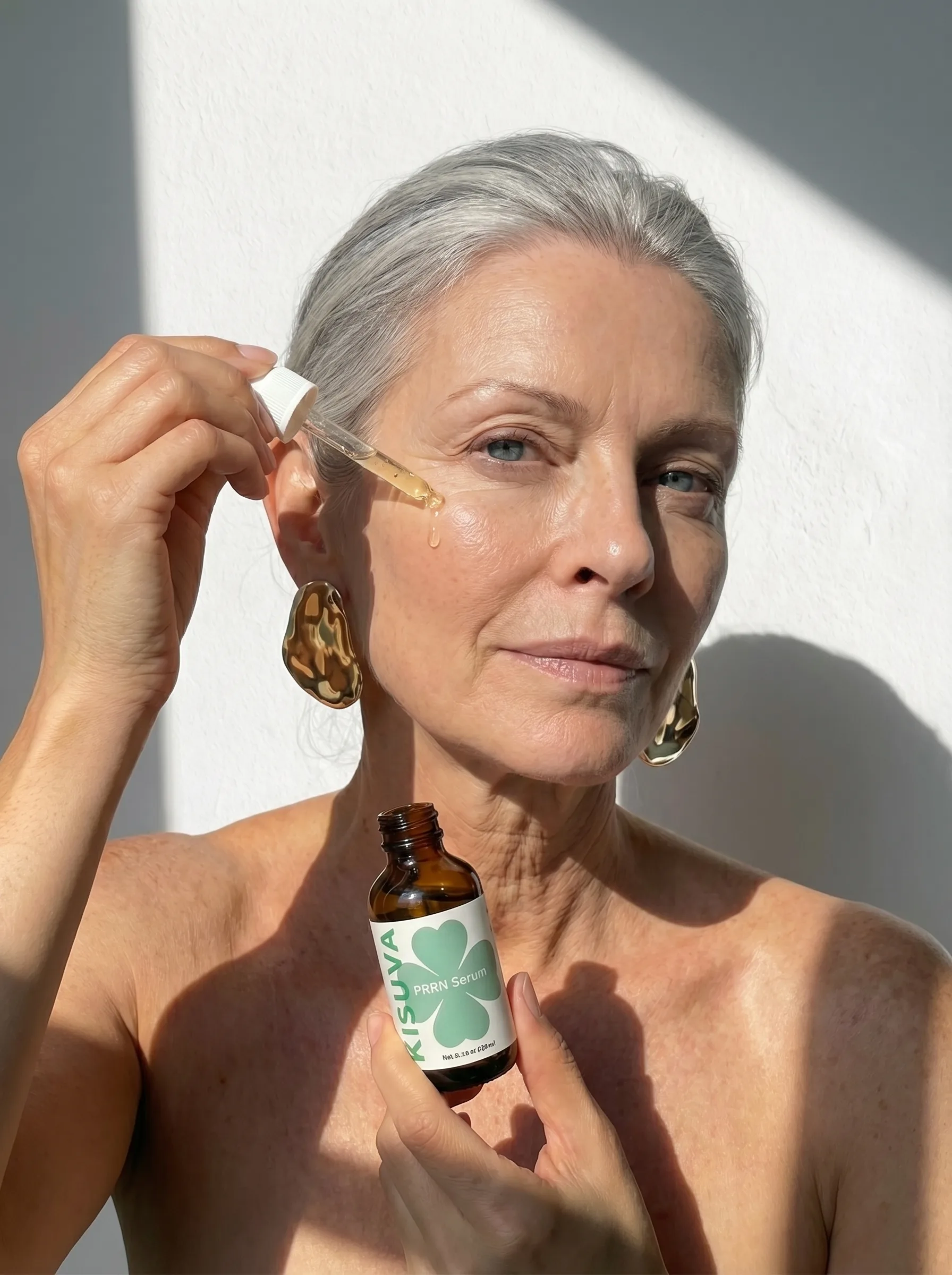 Mature woman applying Kisuva PDRN Serum with dropper