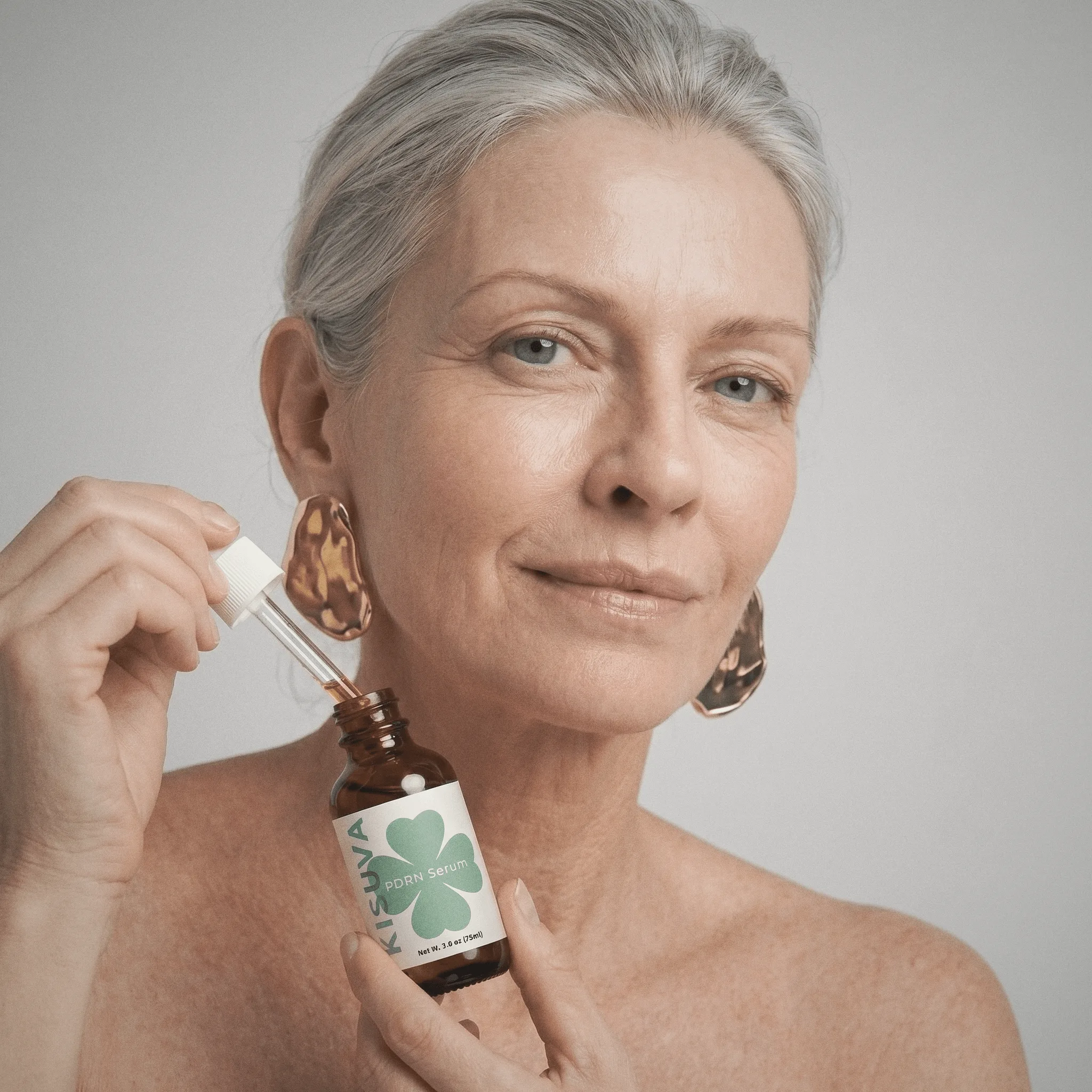 Mature woman holding Kisuva PDRN Serum