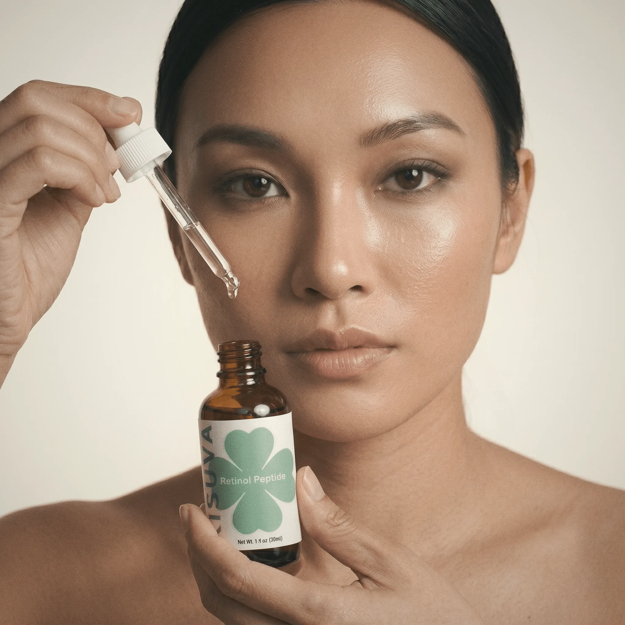 Woman holding Kisuva Retinol Peptide Serum